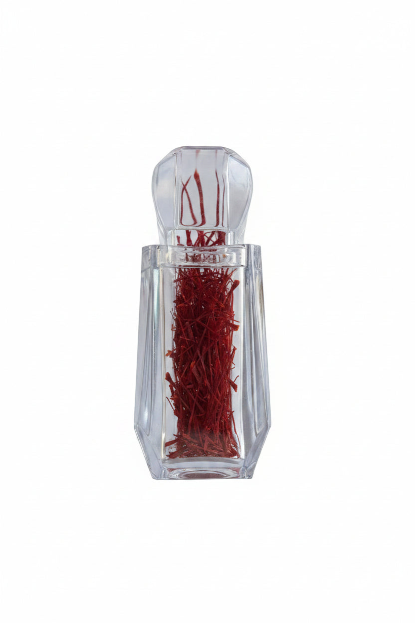 Clear glass bottle with red contents on a white background